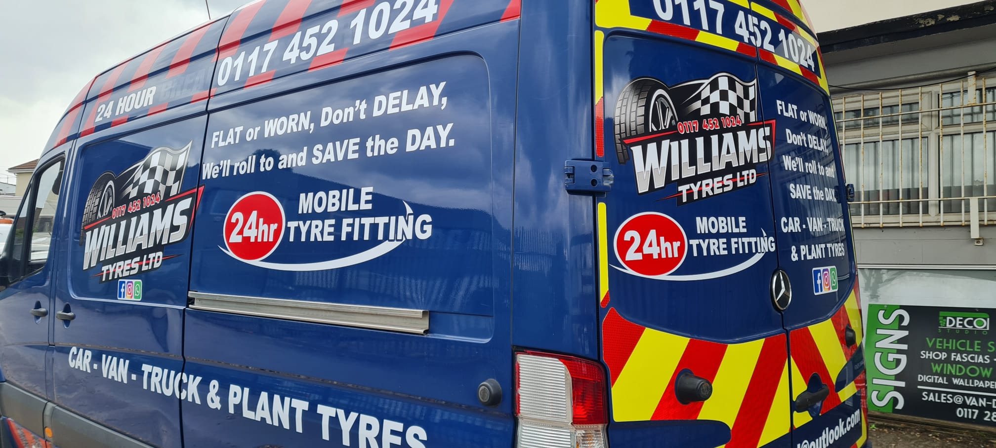 Williams Tyres Ltd blue Mercedes Sprinter rear three-quarter view showing full van graphics both sides with red and yellow Chapter 8 chevrons, fitted by Deco Studio Bristol